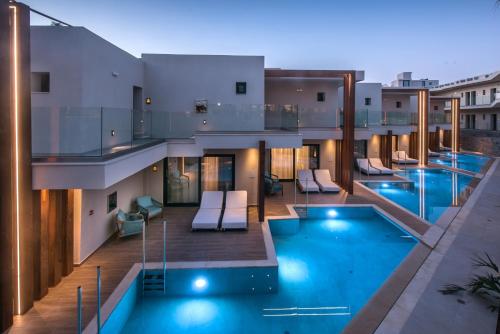 a view of a building with a swimming pool at Noble Hotel & Suites - Adults Only in Gouves