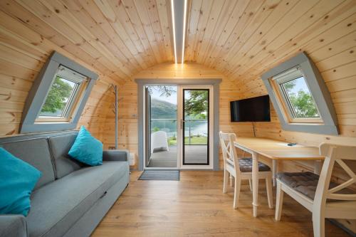 a living room with a couch and a table at Onich Hotel & Lochside Beach Pods in Onich