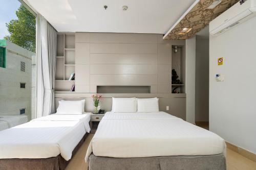 Ένα ή περισσότερα κρεβάτια σε δωμάτιο στο Lucky Star Hotel Nguyen Trai Q5