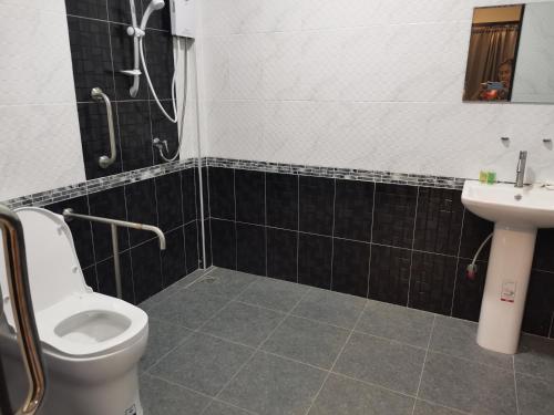 a bathroom with a shower and a toilet and a sink at Numhom Resort in Ban Nong Chum Saeng