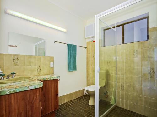 a bathroom with a toilet and a sink and a shower at Seaborne Escape - Port Willunga - C21 SouthCoast Holidays in Port Willunga
