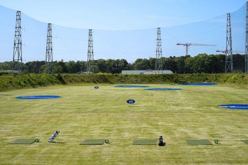 a large grass field with blue frisbees on it at Cosy carré Haussmann, stade de franc, C D G, Paris in Le Blanc-Mesnil
