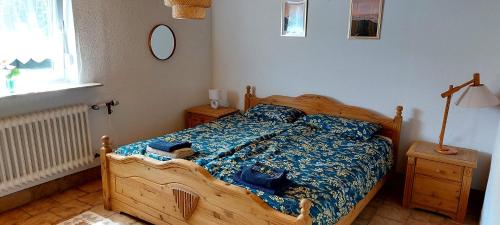 a bedroom with a wooden bed and a window at House of Haiger Ferienwohnung mit Charme in Haiger