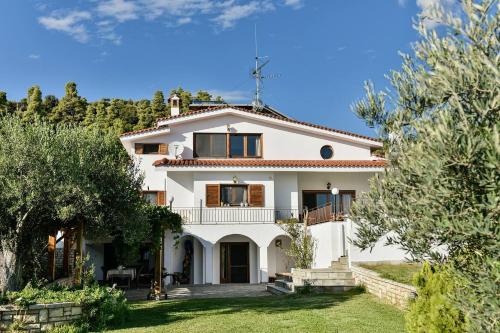 a villa with a view of the house at Azure Coast Seafront Retreat in Mola Kalyva