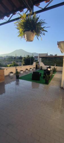 a patio with couches and plants in a building at Vesuvius Dream in Boscotrecase