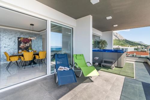 a dining room and kitchen with a table and chairs at Lux Penthouse Panoramic View with jacuzzi in Makarska
