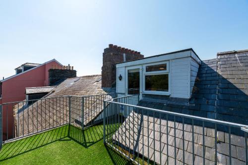 a view from the roof of a house with a balcony at Modern Sea View Apartment in Aberdyfi
