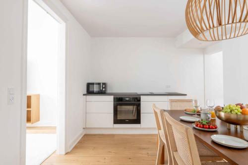 a kitchen with a table with a bowl of fruit on it at Stylish Apartment on Lively Street in Downtown in Copenhagen