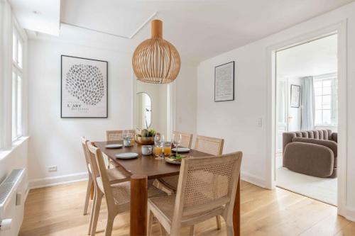 a dining room and living room with a table and chairs at Stylish Apartment on Lively Street in Downtown in Copenhagen