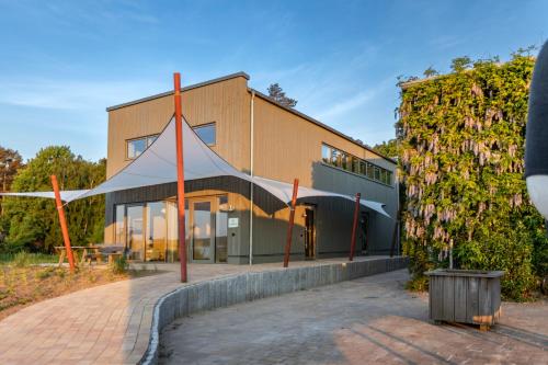 a building with a tent in front of it at Im-Jaich Naturoase Gustow in Gustow