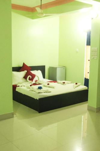 a bedroom with a bed with clothes on it at Grand Selim Resort & Tour – GSRT in Sreemangal