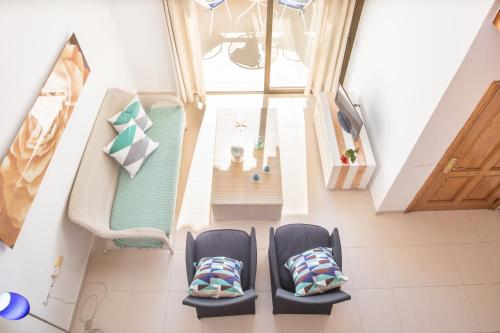 an overhead view of two chairs and a table in a room at Apartment Voltor 2 C By SunVillas Mallorca in Pollença