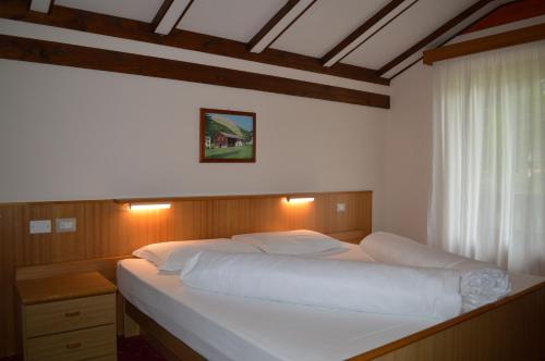 A bed or beds in a room at Hotel Stella Alpina