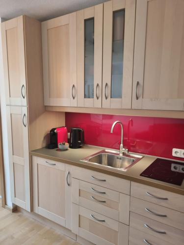 a kitchen with white cabinets and a sink at Chalet Kitzbühelblick in Kitzbühel