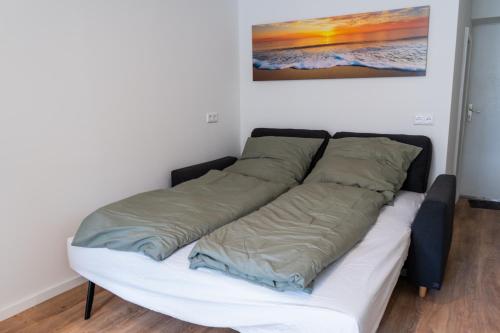 a bed with two pillows on it in a room at City Apartments Old Town Düsseldorf in Düsseldorf