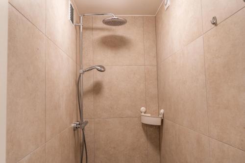a shower stall with a shower head in a bathroom at City Apartments Old Town Düsseldorf in Düsseldorf