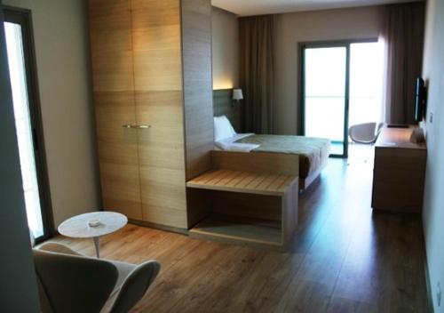a hotel room with a bed and a table and chairs at Boutique Hotel in Beirut