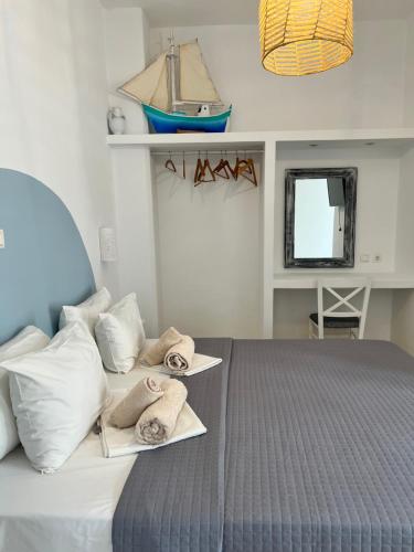 a bedroom with a bed with towels on it at Daphne in Naousa