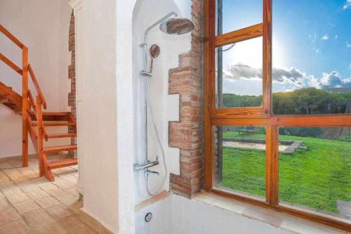 a bathroom with a shower and a large window at Mas Dels Arcs Con piscina Muy cerca de la playa in Calonge