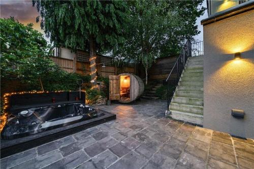 a backyard with a hot tub next to a building at The Ridge London - Luxury Designer Villa with hot tub and sauna, Bexley borough of London in London