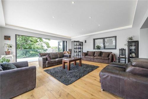 a large living room with couches and a table at The Ridge London - Luxury Designer Villa with hot tub and sauna, Bexley borough of London in London