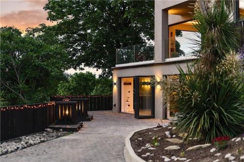a house with a walkway leading to the front door at The Ridge London - Luxury Designer Villa with hot tub and sauna, Bexley borough of London in London