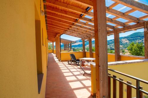a balcony of a house with a table and chairs at Rifugio La PRINCIPESSA in Morano Calabro