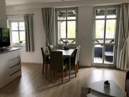 a living room with a dining room table and chairs at Apartmán Krušné hory - Erzgebirge in Horní Blatná
