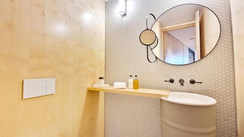 a bathroom with a sink and a mirror at The Urban Retreat by LovelyStay in Funchal