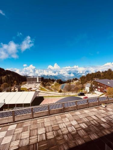 a view of a city from a building with a fence at studio, 2 personnes, Les Balcons de Recoin in Chamrousse