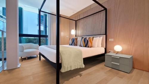 a bedroom with a large bed and a chair at The Urban Retreat by LovelyStay in Funchal