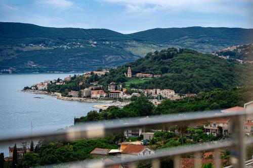a view of a town and a body of water at Golden View Apartments in Zelenika