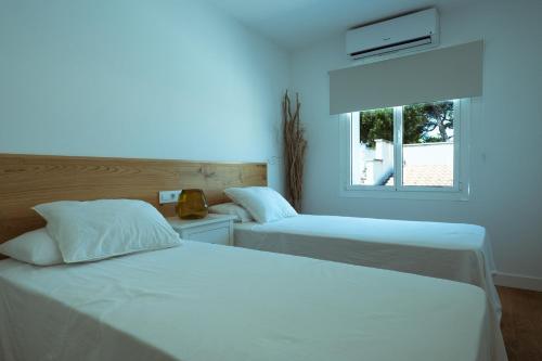 two beds in a room with a window at 272 Casa Sol ETV7727 by Mallorca Charme in Can Picafort