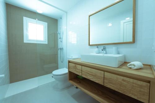 a bathroom with a sink and a toilet and a mirror at 272 Casa Sol ETV7727 by Mallorca Charme in Can Picafort