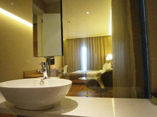 a bathroom with a sink and a living room at Boutique Hotel in Beirut