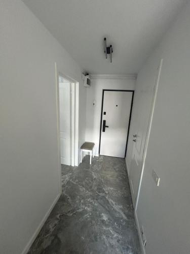 an empty room with a hallway with a door at Studio Ermanos in Curtea de Argeş