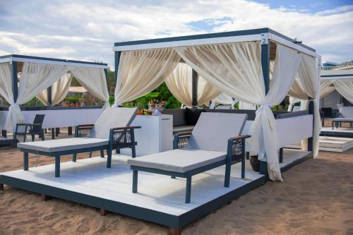 a group of chairs sitting under a canopy on the beach at Crystal Centro Resort - Ultimate All Inclusive in Lara