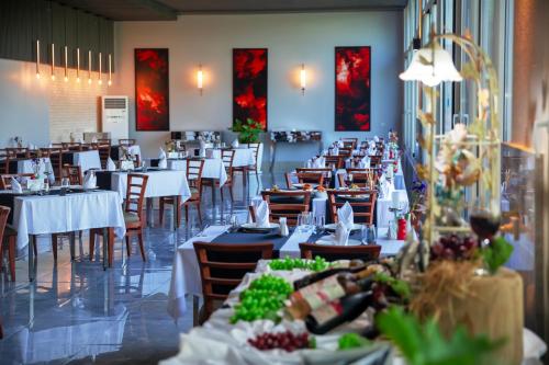 a dining room with white tables and chairs and tablesearcher at Crystal Centro Resort - Ultimate All Inclusive in Lara