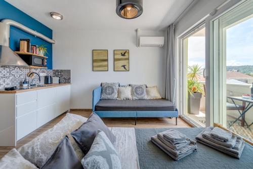 a living room with a couch and a kitchen at Trogir Downtown Apartments in Trogir