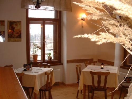 two tables in a restaurant with white table cloth at Pension Na Hradbach in Tábor