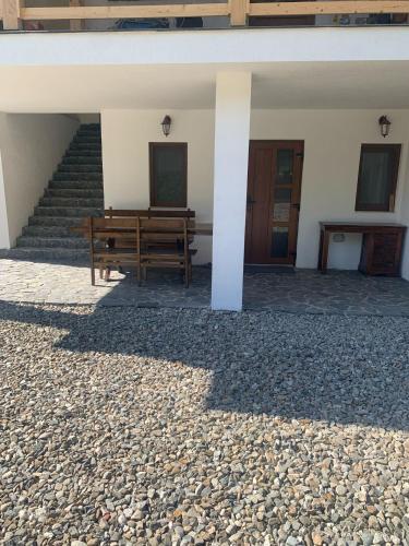 a bench in front of a building with stairs at Casa Mai in Vişeu de Sus