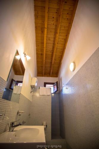 a bathroom with a sink and a ceiling at B&B Baglio Maragani in Maragani