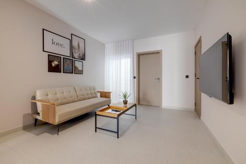 a living room with a couch and a table at Manoel De Vilhena Holiday Apartments in Il-Gżira