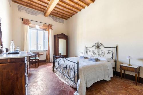 a bedroom with a bed and a table and a sink at Palazzo Ninci in Civitella in Val di Chiana