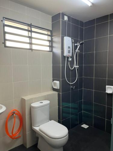 a bathroom with a toilet and a shower at Homestay A&A in Sungai Petani
