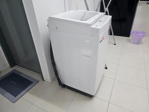 a white refrigerator with a sink on top of it at Homestay A&A in Sungai Petani
