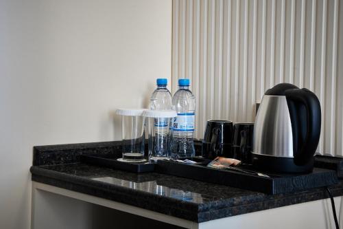 a counter with two bottles of water on it at Diamond Hotel Shymkent in Shymkent