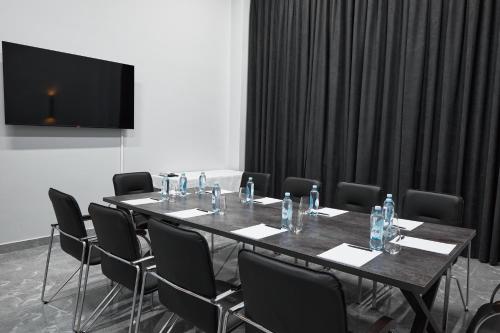 a conference room with a long table and chairs at Diamond Hotel Shymkent in Shymkent