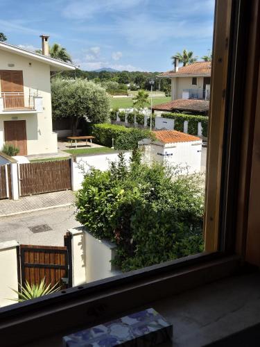 a view of a courtyard from a window at Villa Sabaudia in Sabaudia