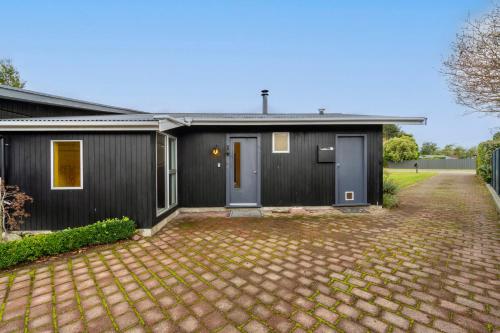 a home with a black house with a driveway at 27 on Henry - Te Anau Holiday Home in Te Anau